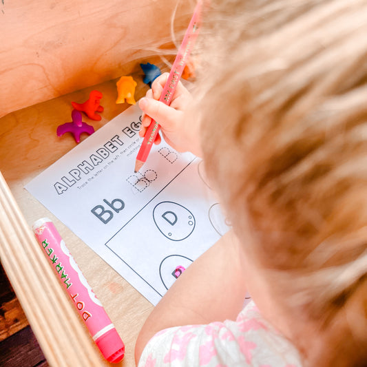 Toddler Counting Dinosaurs on a Worksheet